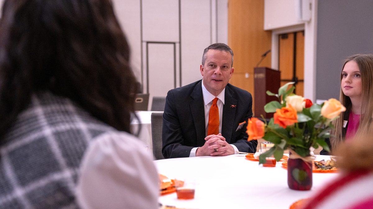Dr. Downs sitting with students