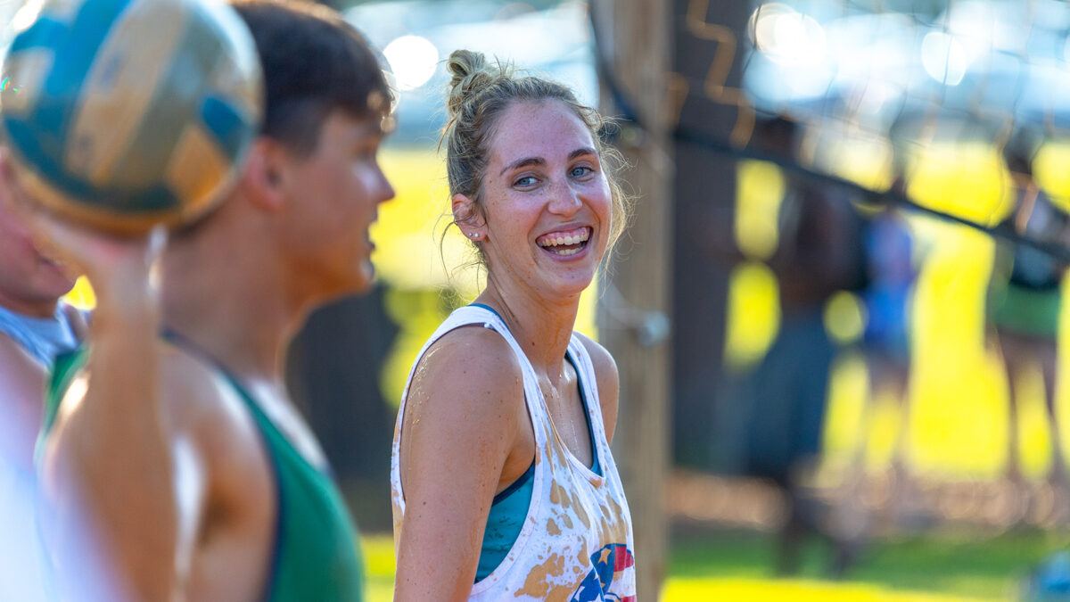 students playing mud volleyball