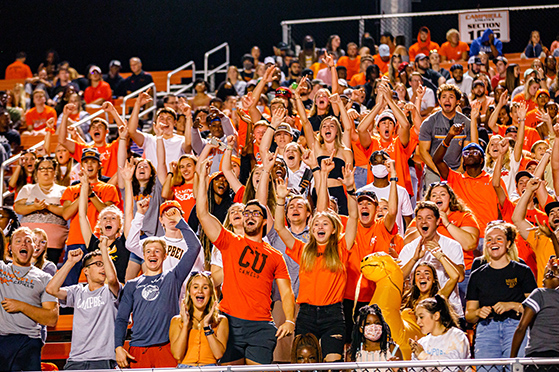 football players run onto field