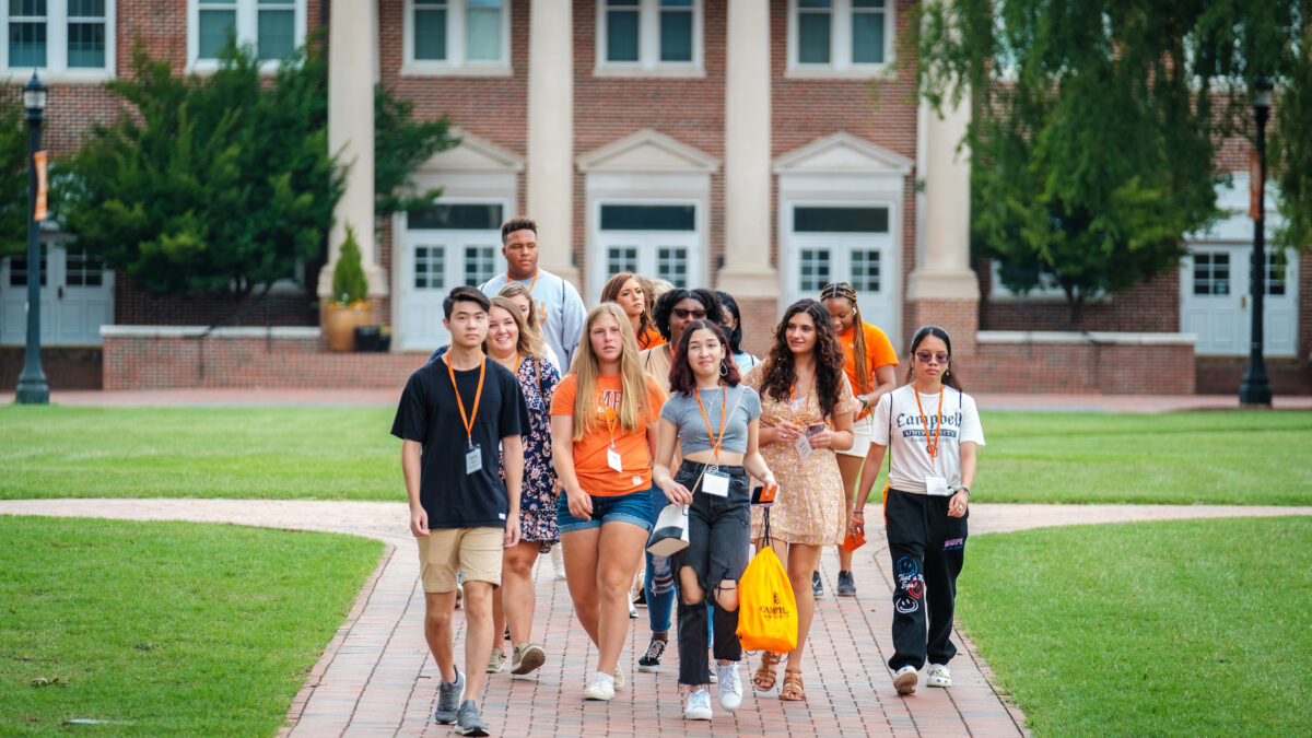 A group of students cheerfully tour our campus